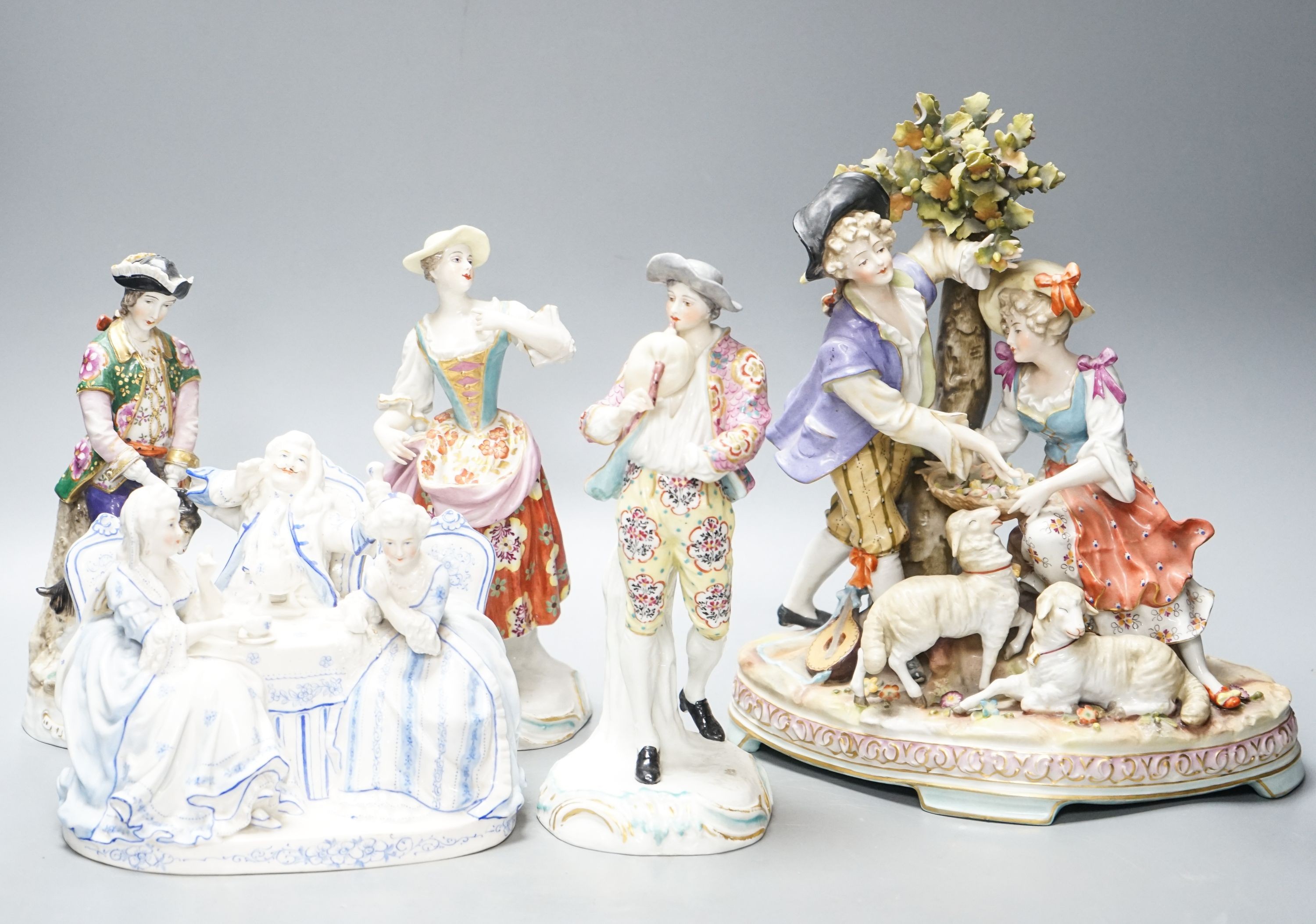 A Sitzendorf group of a Shepherd and shepherdess, three other Continental costume figures and a group (5) 27cm